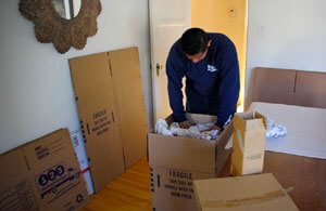 mover packing in a livingroom