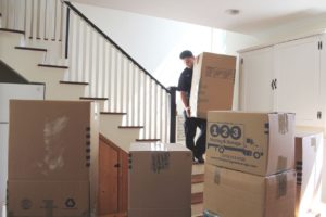 123 Mover Carrying Boxes Down Stairs